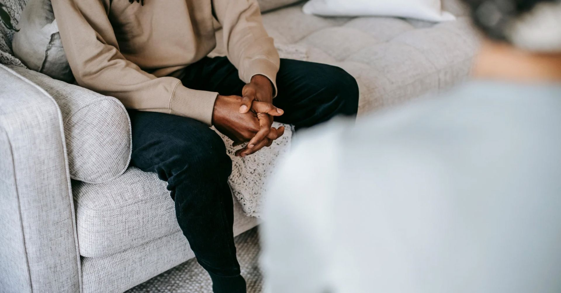 Client and therapist sitting in a private session, showing an open conversation in a comfortable counselling environment.
