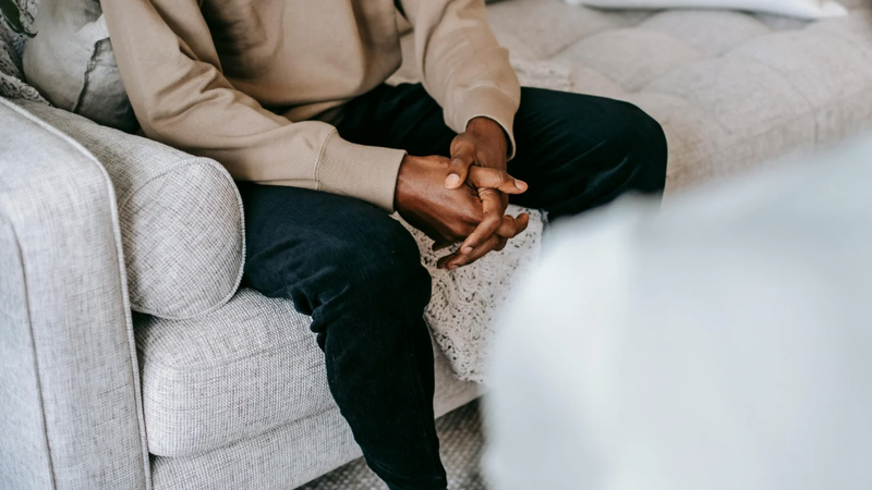 Client and therapist sitting in a private session, showing an open conversation in a comfortable counselling environment.