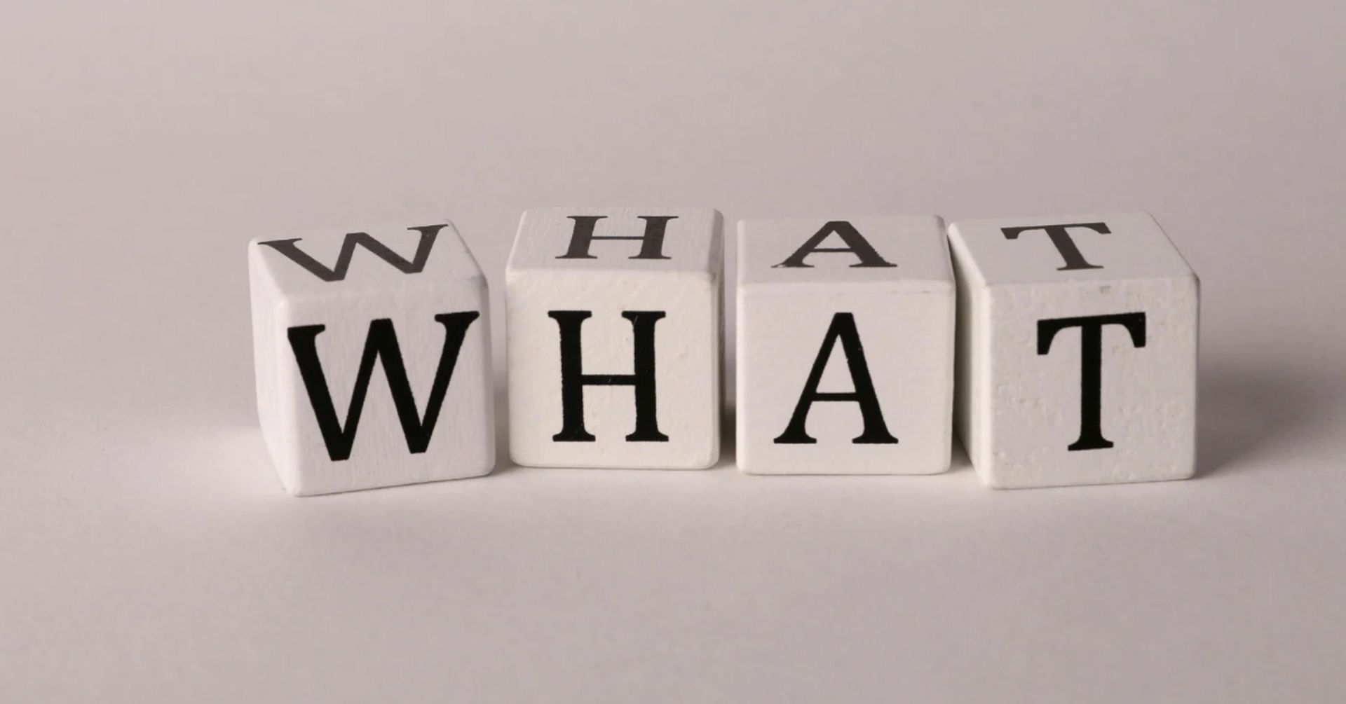 Wooden letter blocks spelling what, symbolising what to expect from counselling sessions