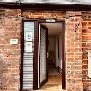 Entrance to June Reid Counselling therapy room in a brick building, welcoming clients for counselling sessions.