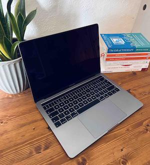 Laptop on desk representing online counselling sessions with June Reid Counselling.